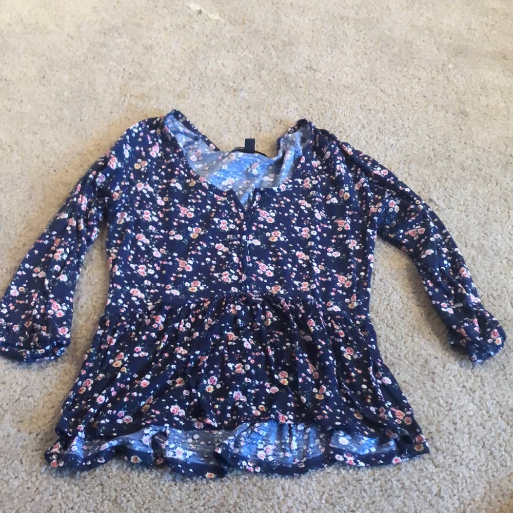 Almost Famous brand shirt with ruffled bottom. Cinched sleeves at three quarters